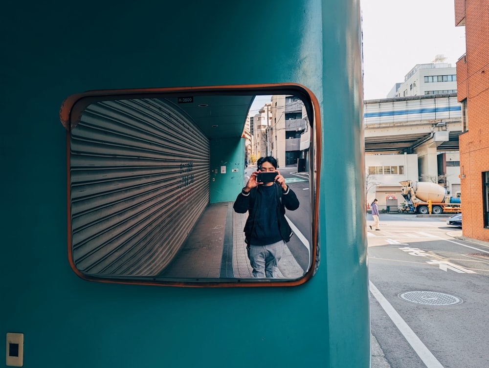 a man taking a picture of himself in a mirror