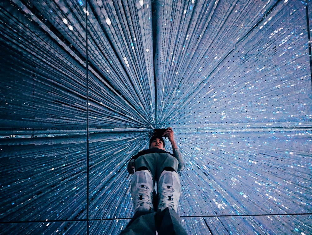 a person standing in front of a star filled wall