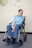 a man sitting in a wheel chair in a room