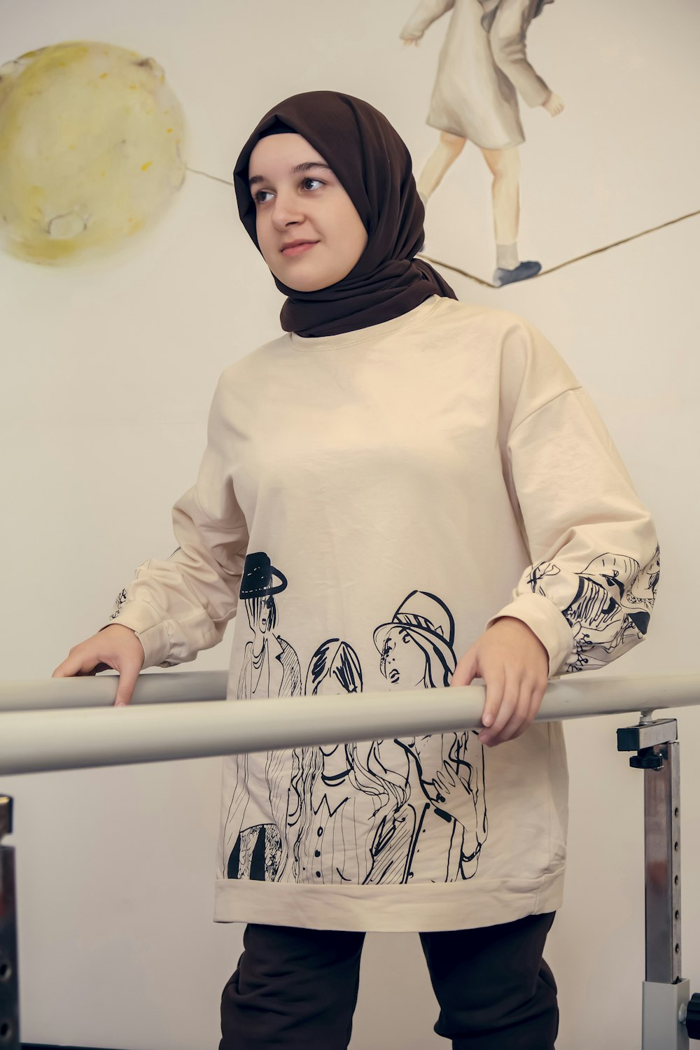 a woman in a hijab standing next to a rail