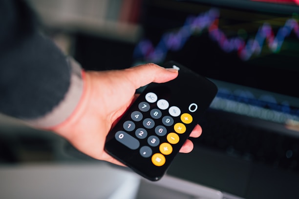 A man holding a calculater working out the cost of office cleaning services