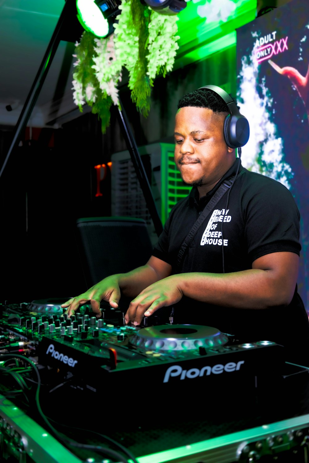 a man that is sitting at a dj's desk