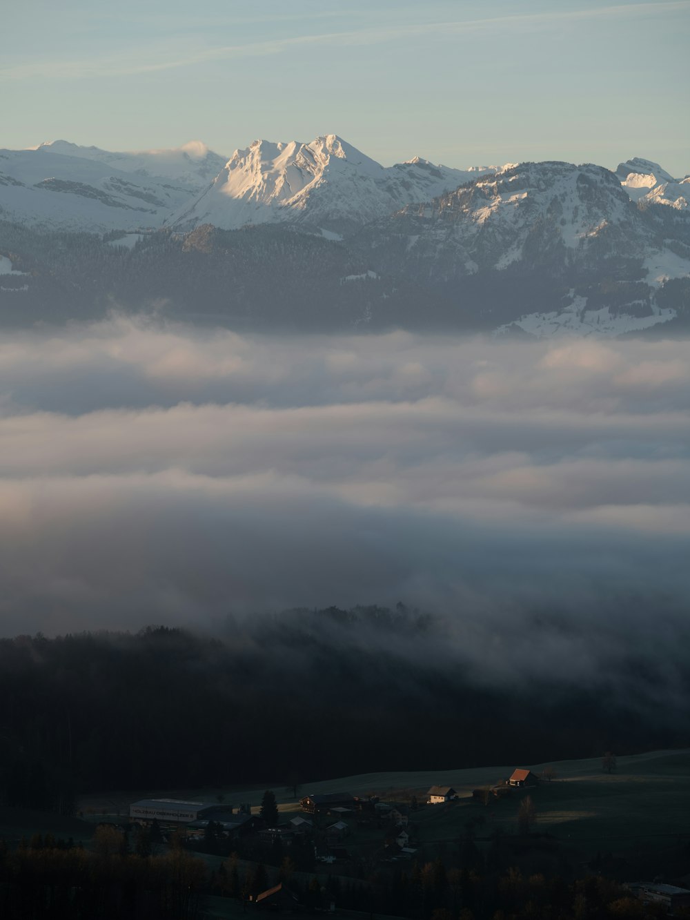 a view of a mountain covered in clouds