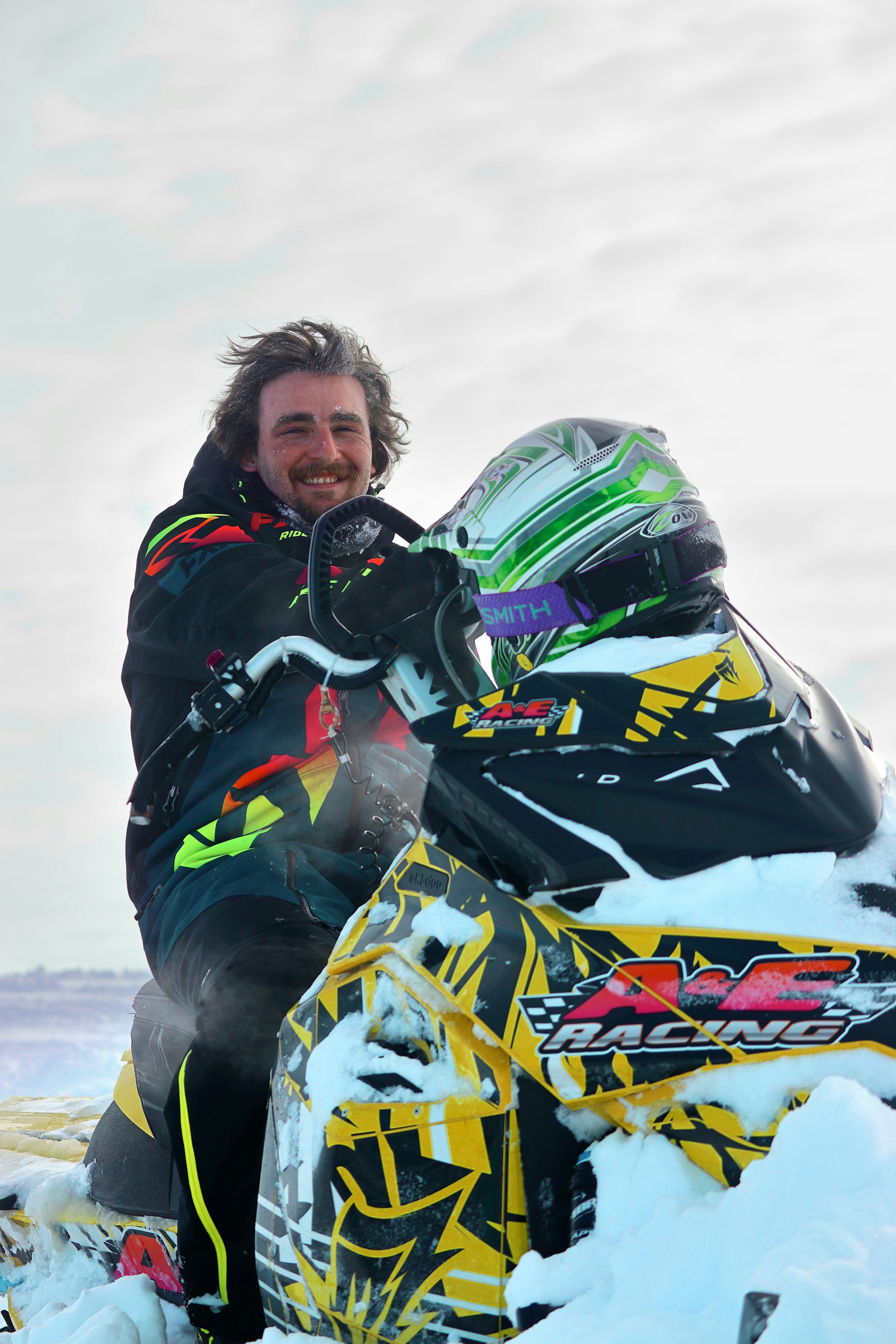 A man sitting on a snowmobile in the snow photo – Free Bighorn ...