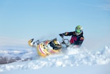 a person riding a snowmobile in the snow