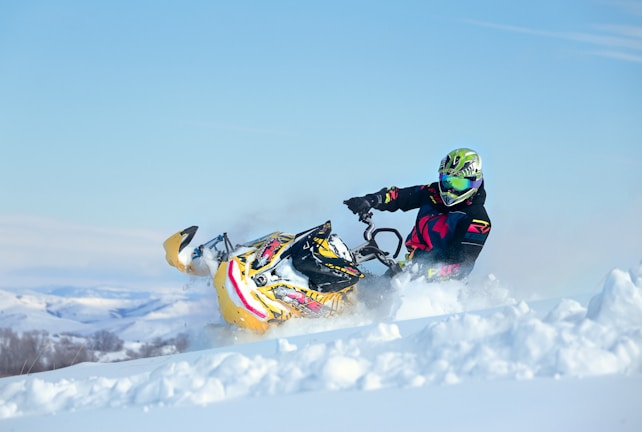 a person riding a snowmobile in the snow