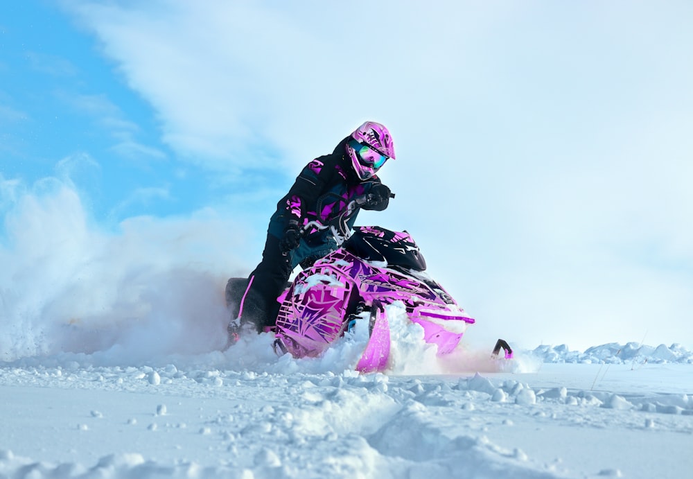 a person riding a snowmobile in the snow