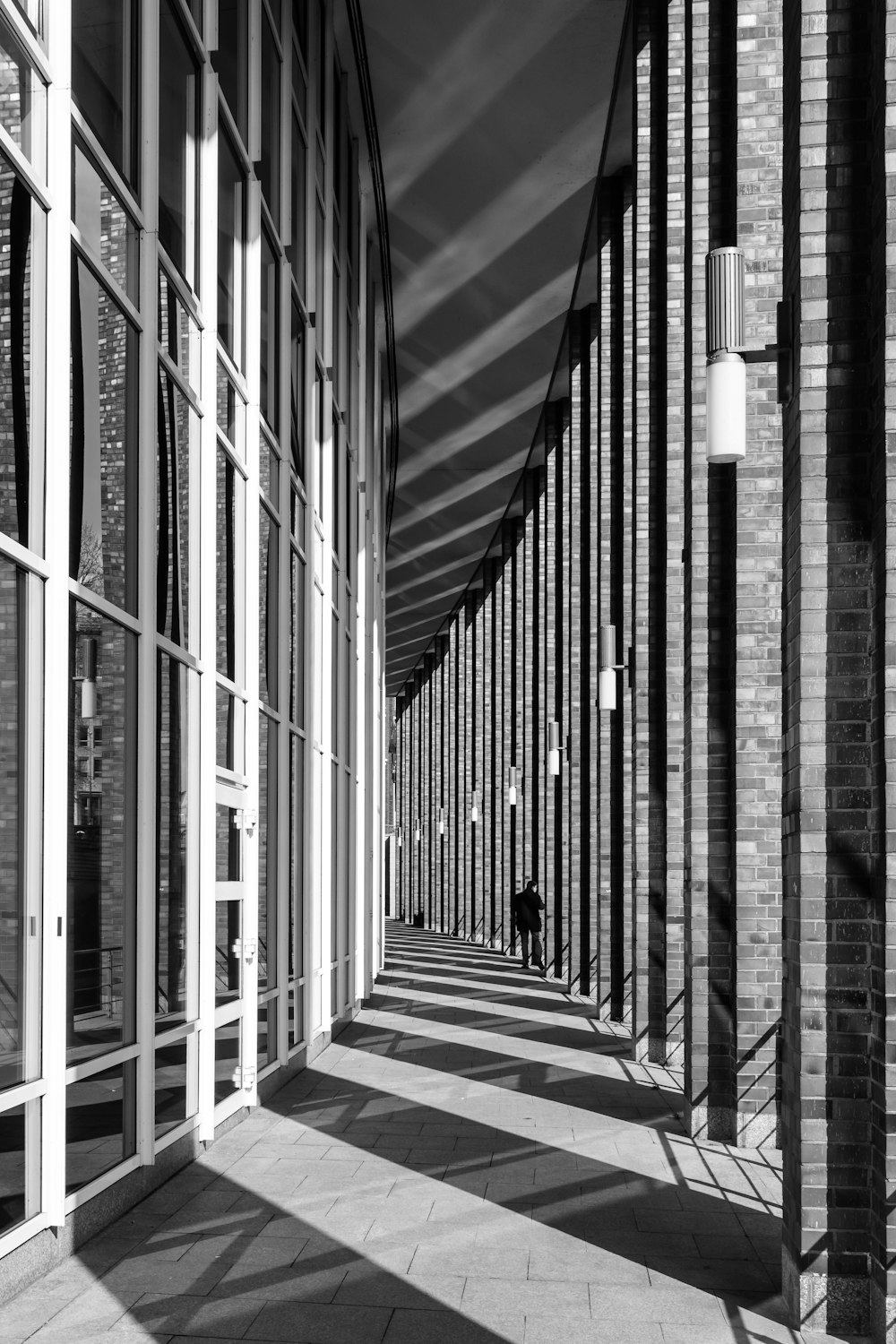 a black and white photo of a long hallway