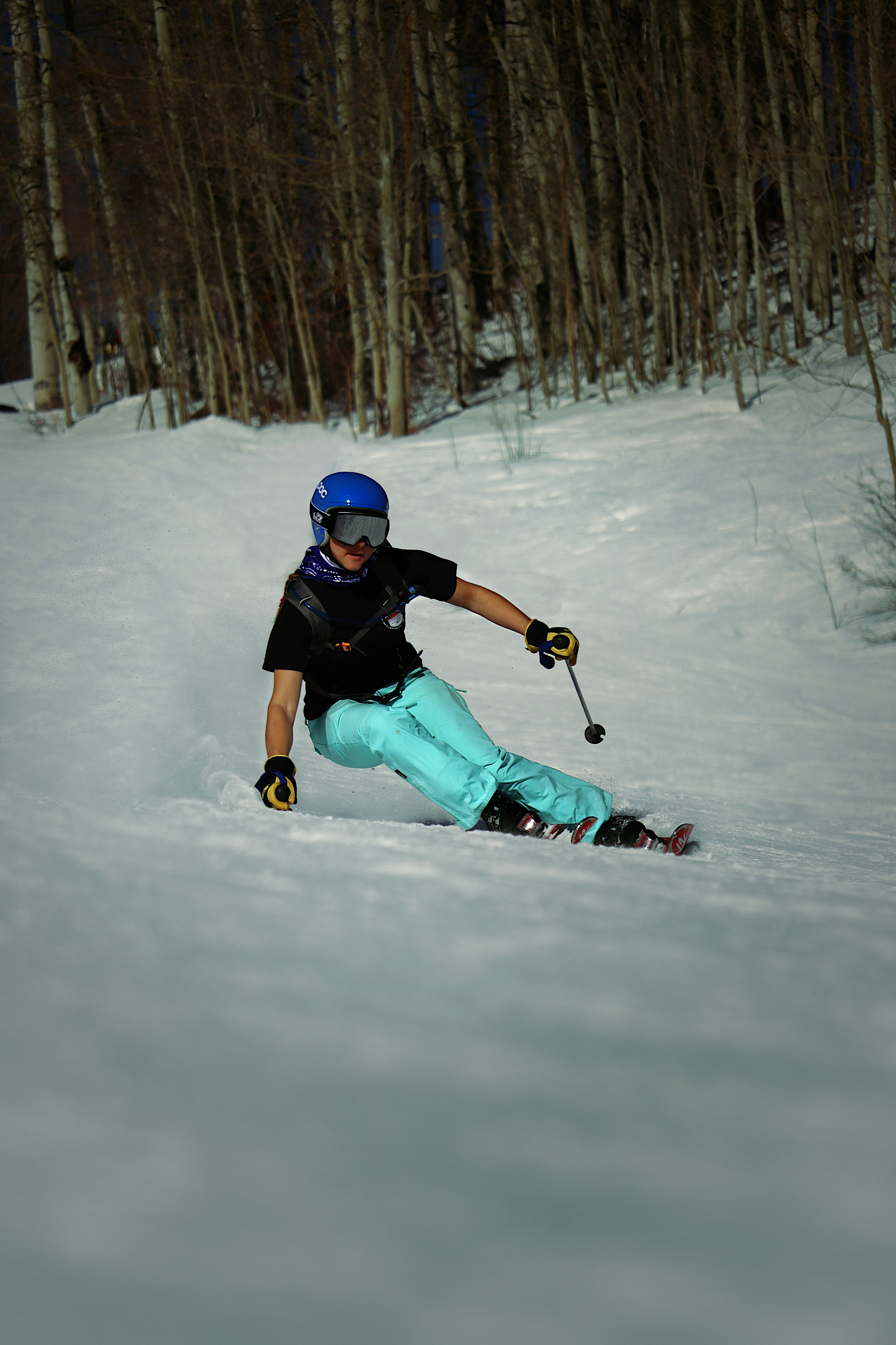 a person riding skis down a snow covered slope
