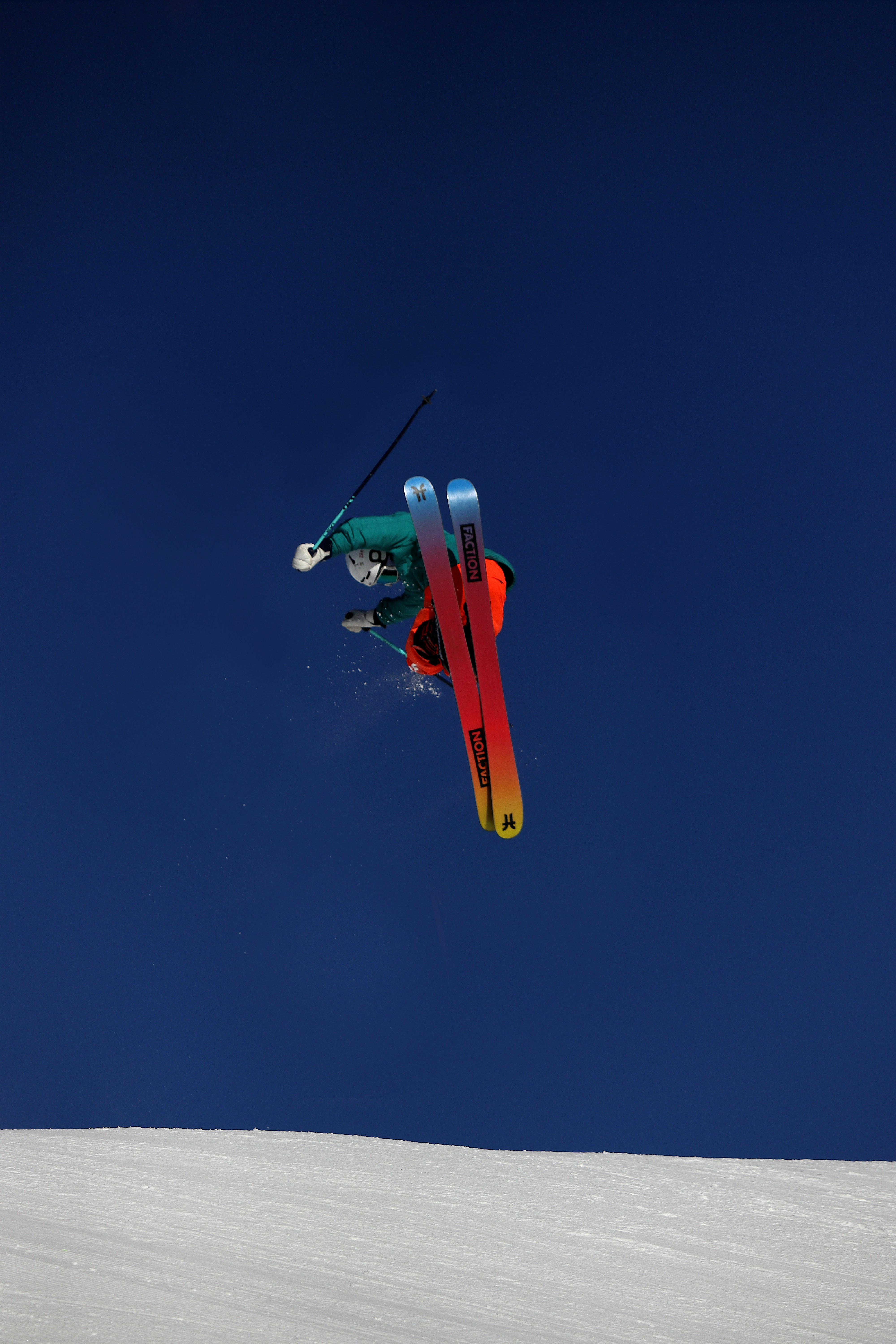 a man flying through the air while riding skis