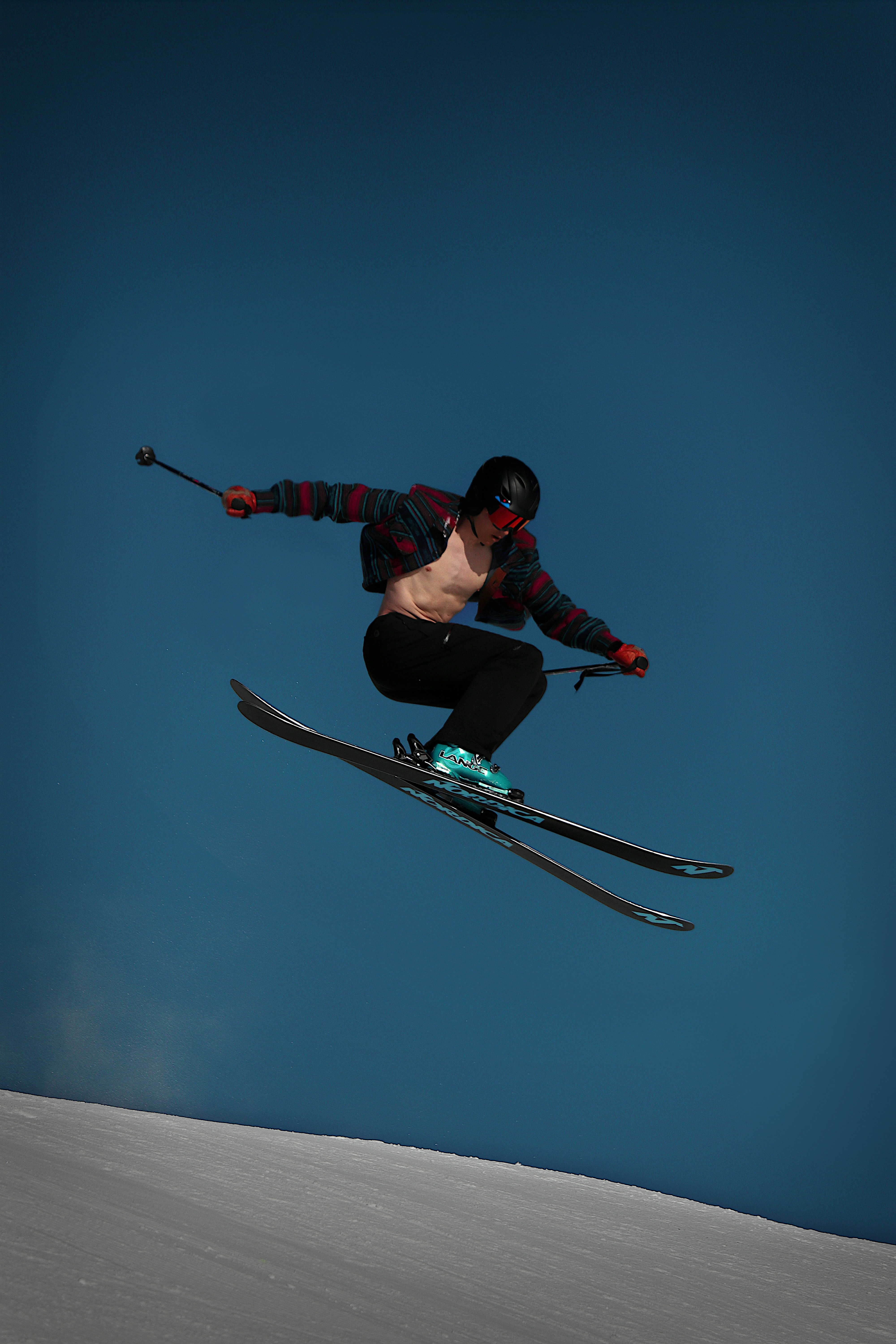a man flying through the air while riding skis