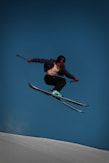 a man flying through the air while riding skis