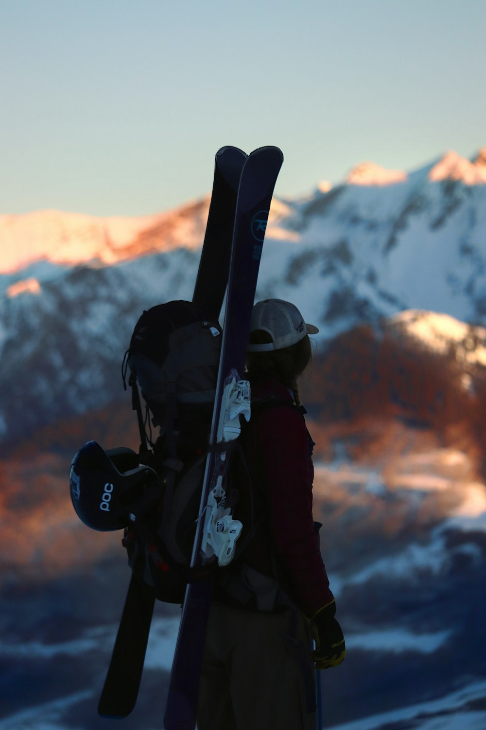 a person with a backpack and a pair of skis