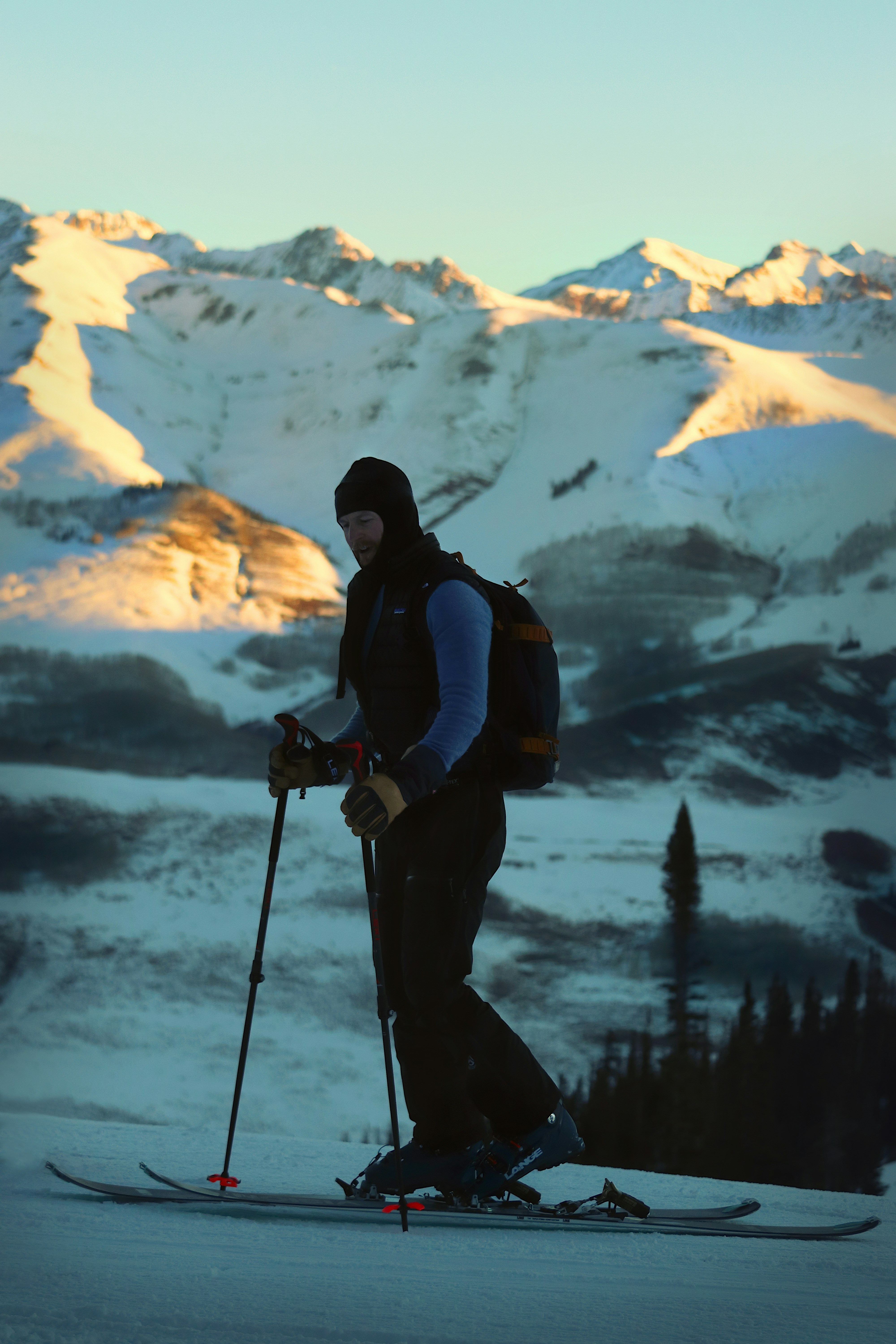 a man riding skis on top of a snow covered slope