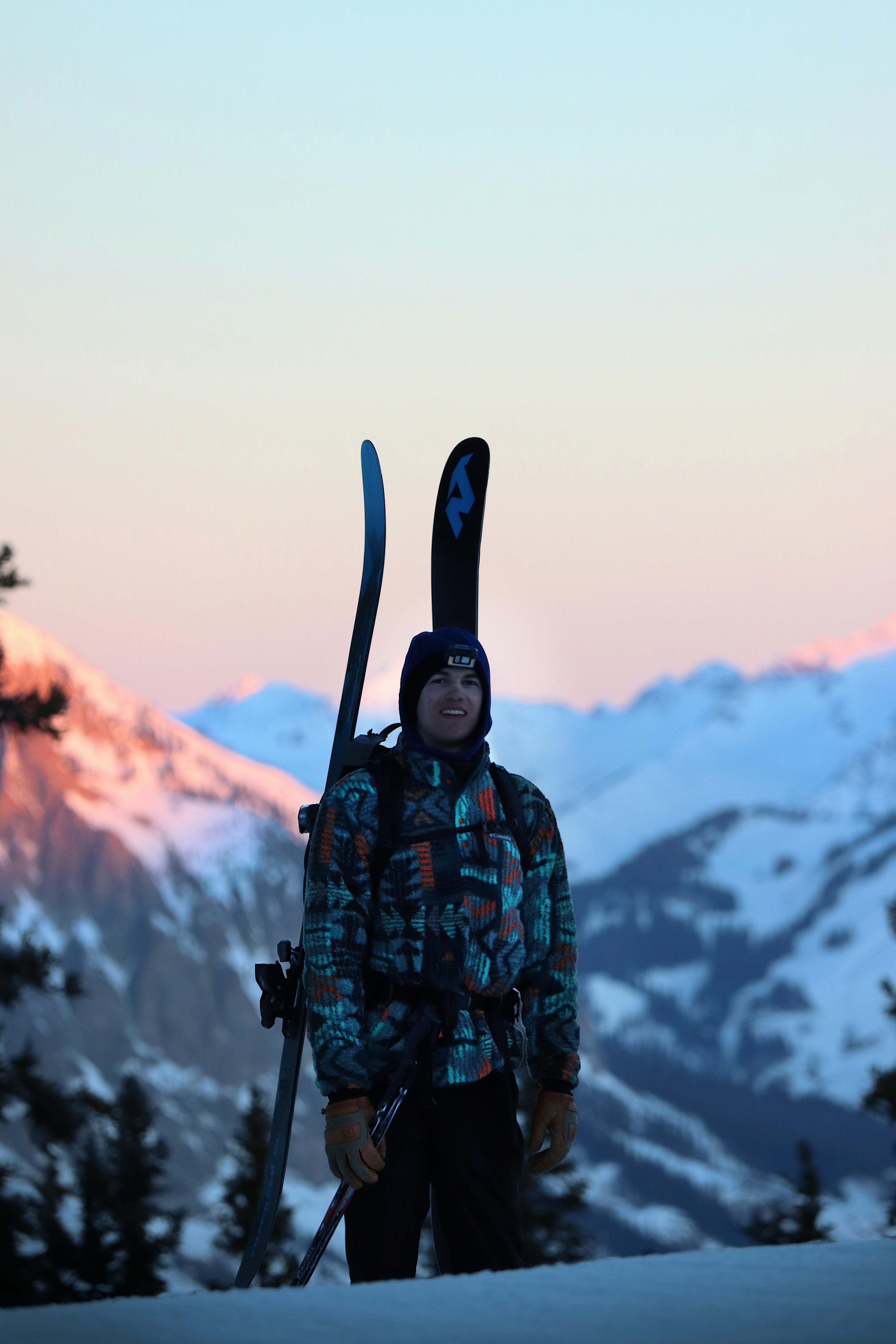 a man with skis and ski poles standing in the snow
