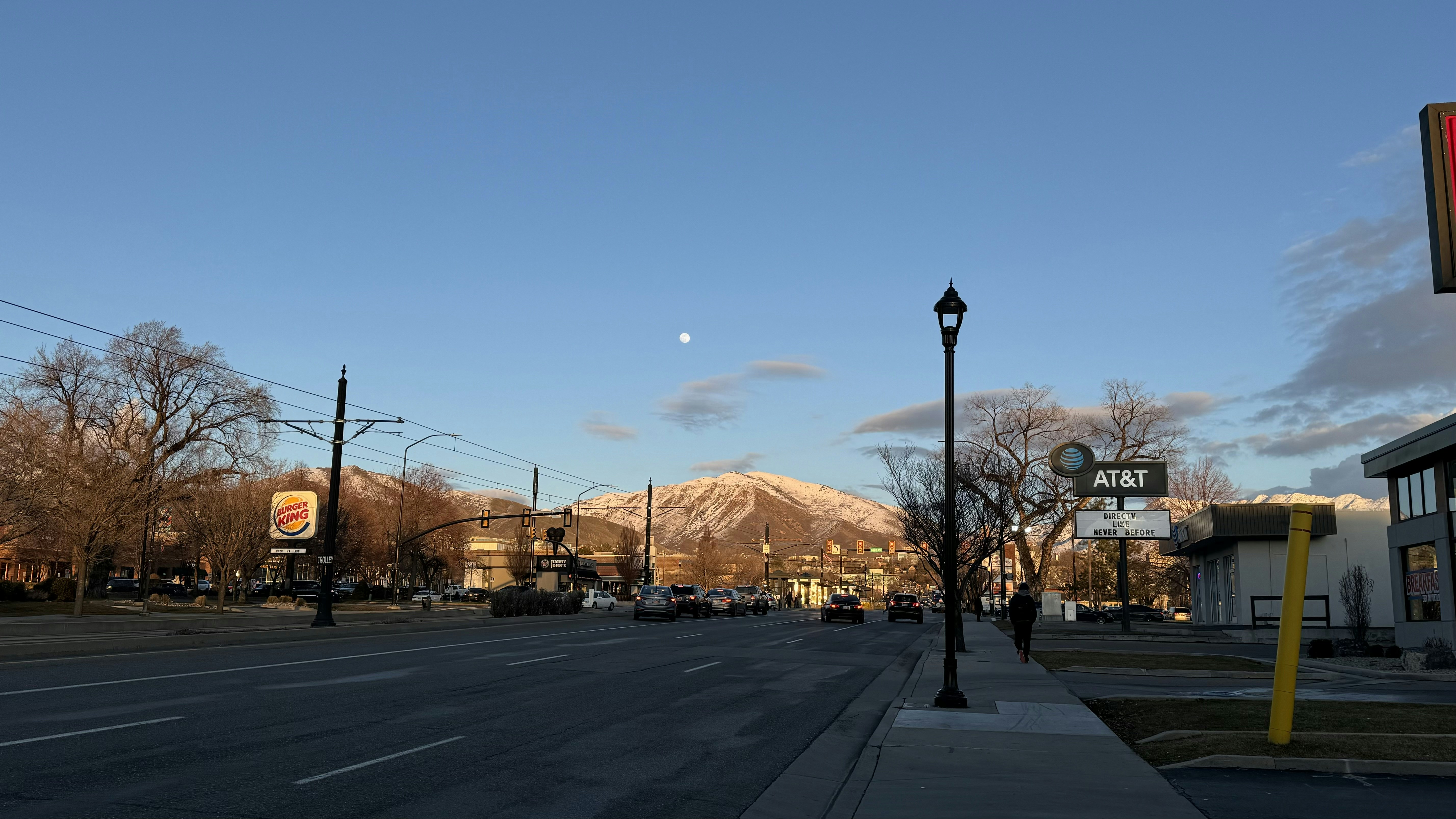 a city street with a mountain in the background