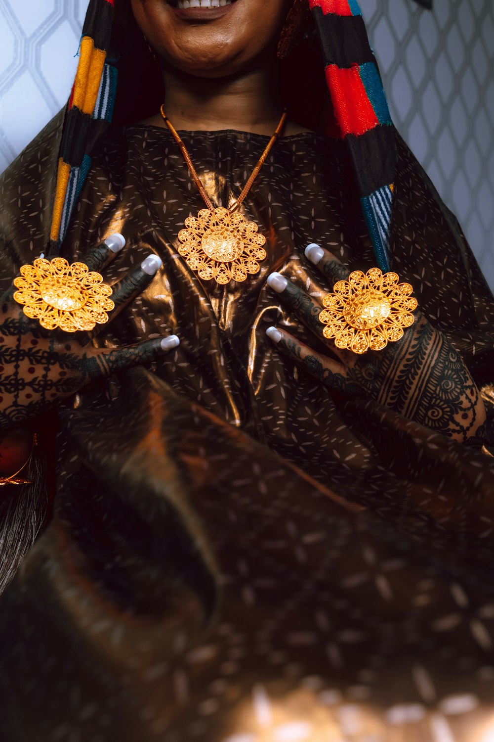 a woman wearing a gold and red headdress