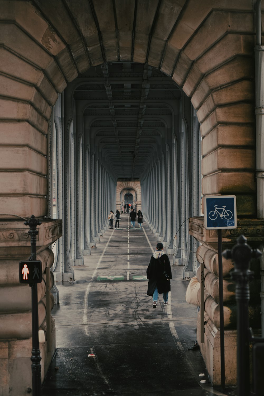 a person walking down a street with a bike