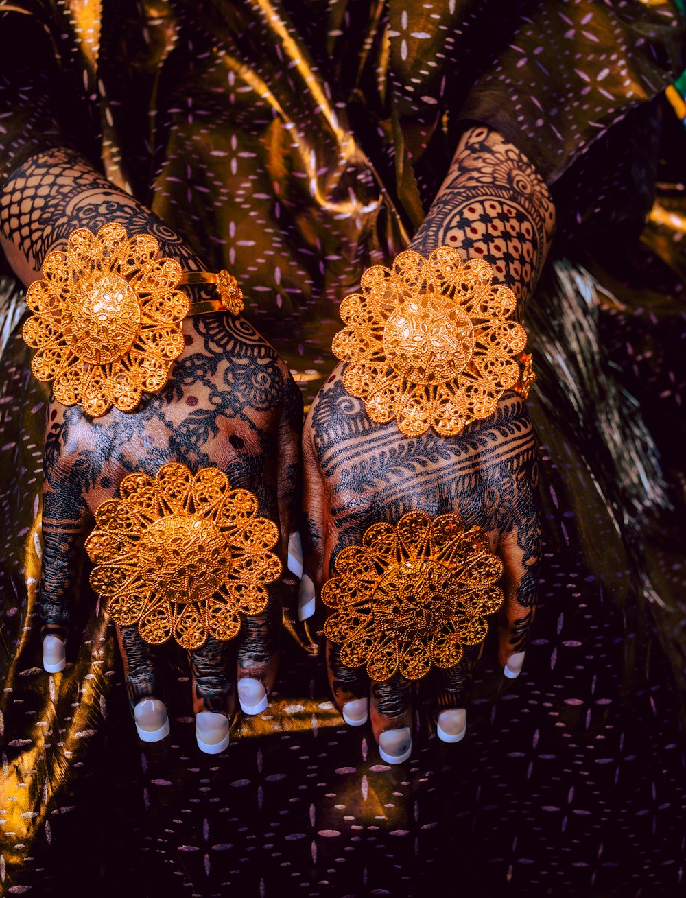 a pair of hands with intricate designs on them