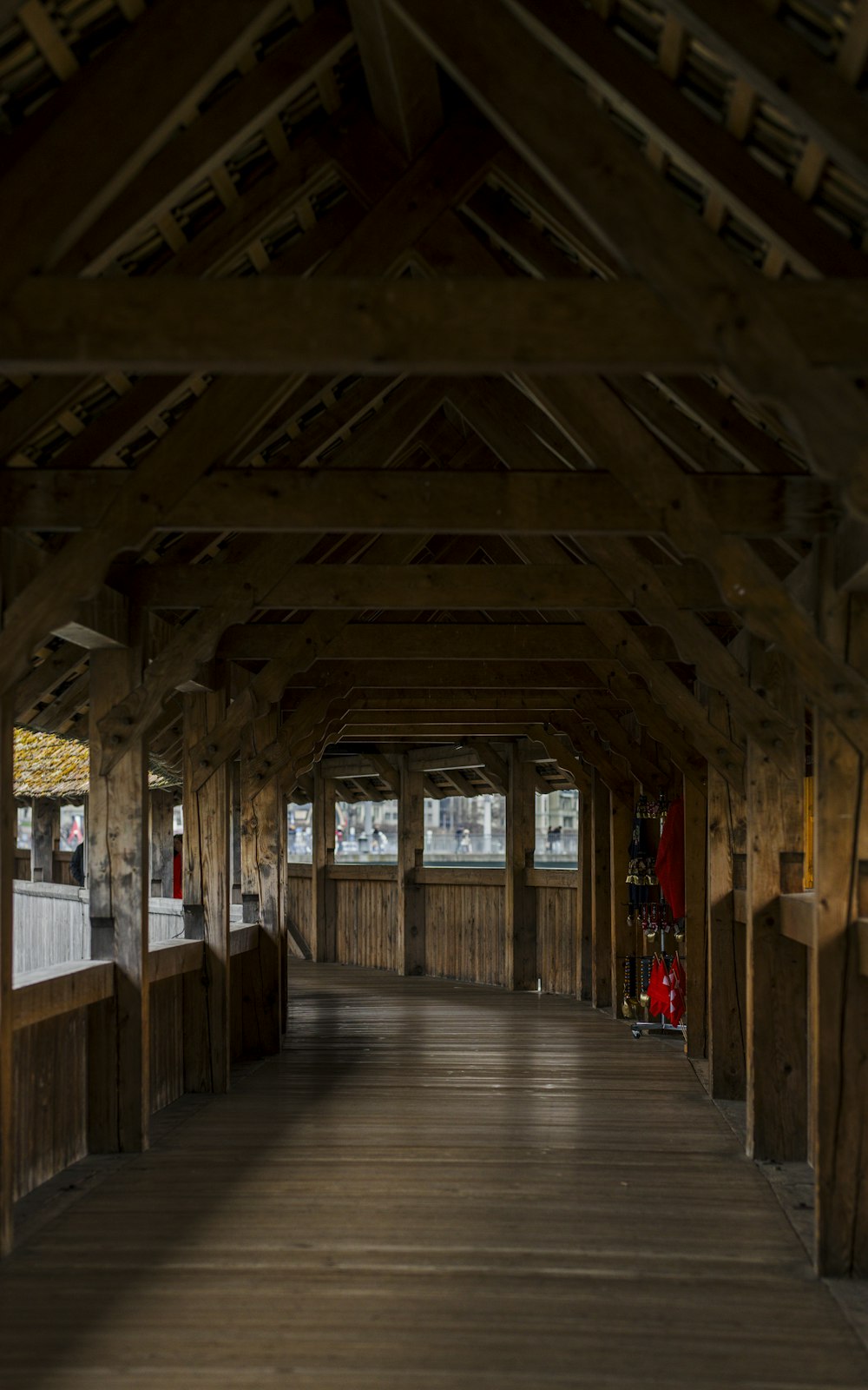 a long covered walkway with a clock on the side of it