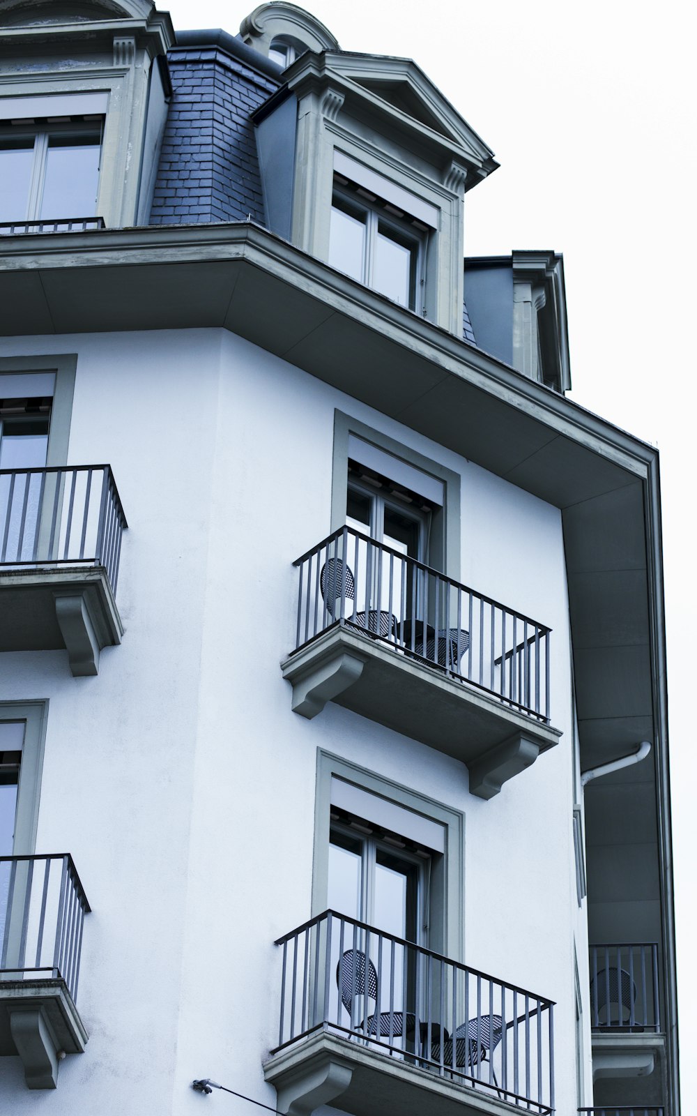 a tall white building with balconies and balconies