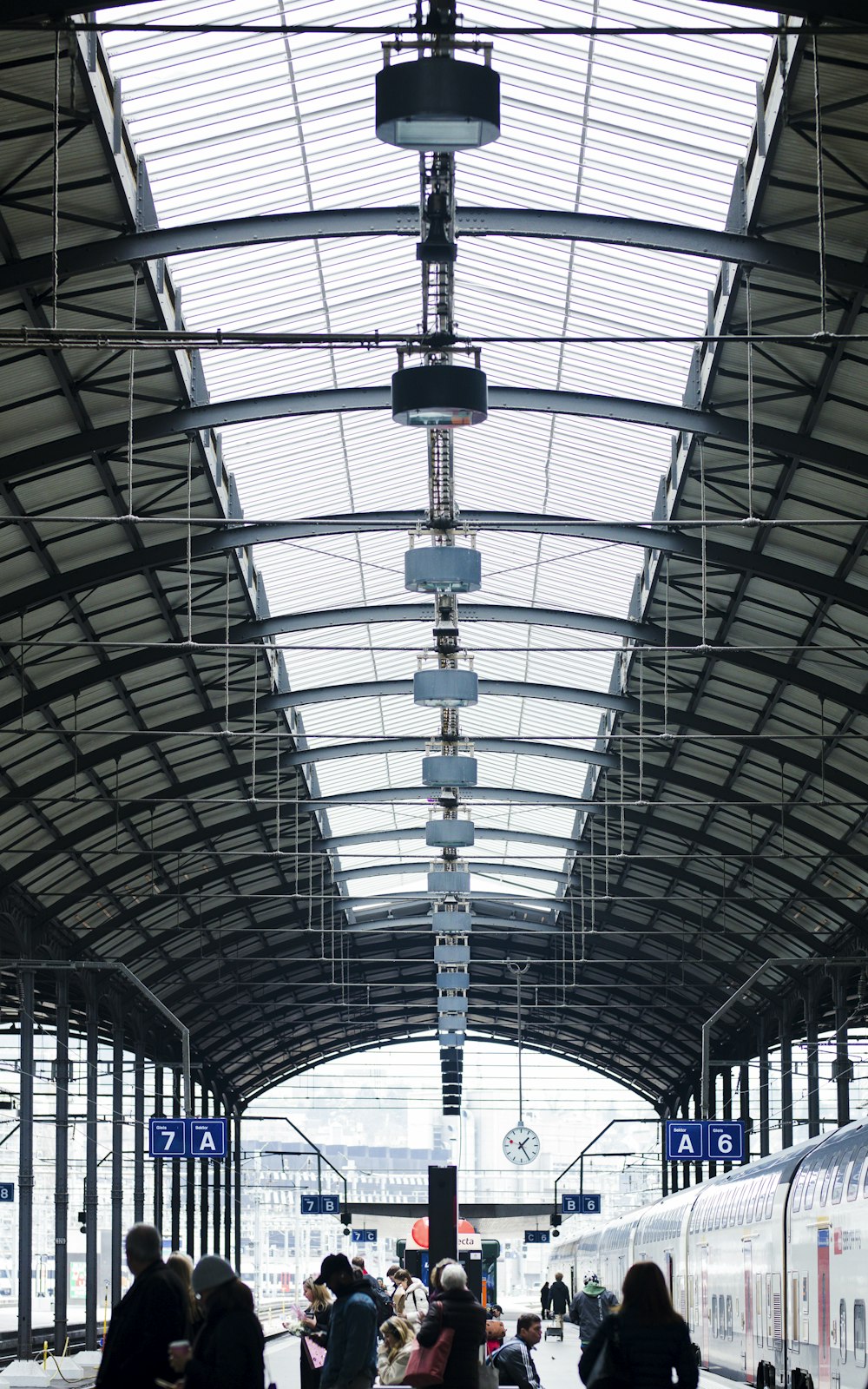 a train station with people waiting for the train