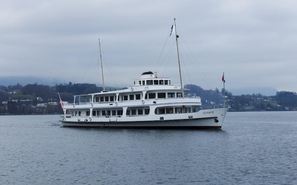 a large white boat floating on top of a body of water