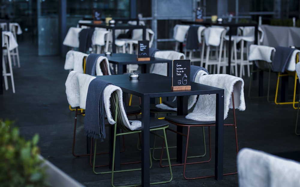 a restaurant with tables and chairs covered in blankets