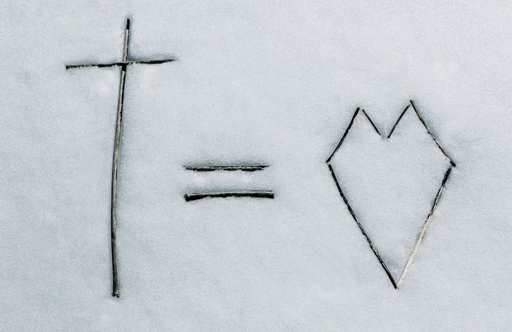 a cross and a line drawn in the snow