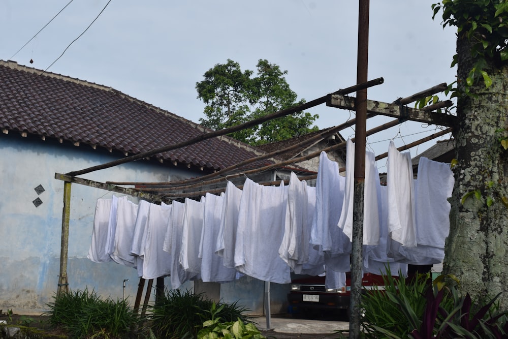 a line of clothes hanging from a clothes line next to a building