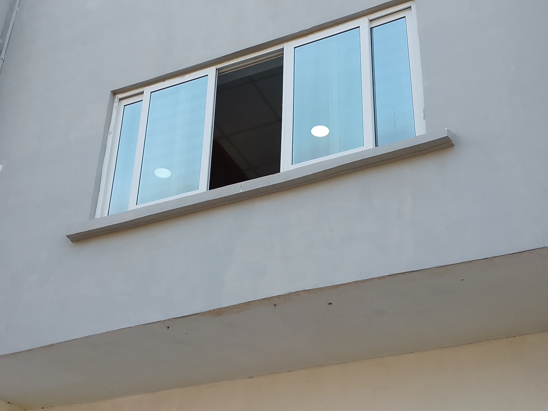 a white building with a window and a light