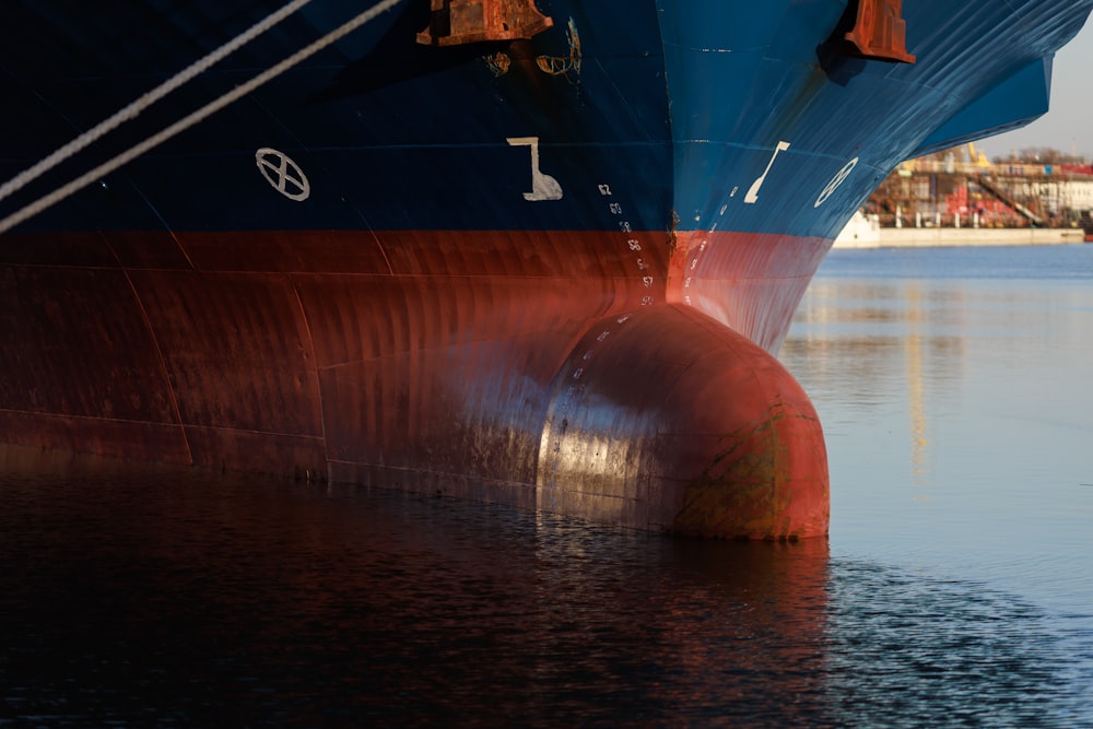 a large blue and red boat in the water