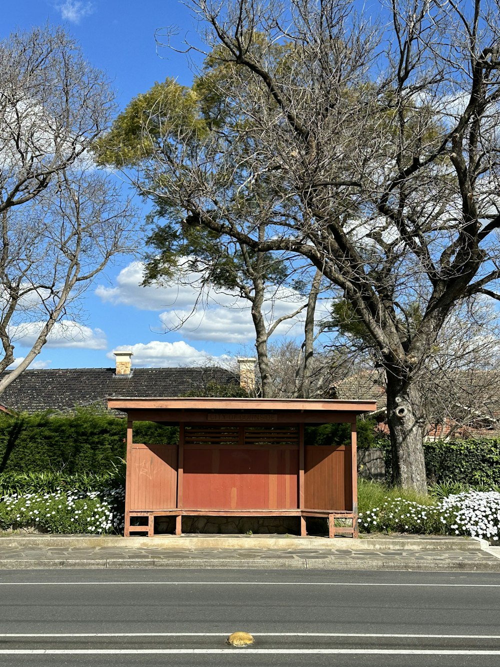a small wooden structure sitting on the side of a road