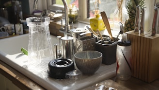 a kitchen sink with a variety of kitchen utensils