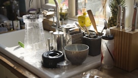 a kitchen sink with a variety of kitchen utensils