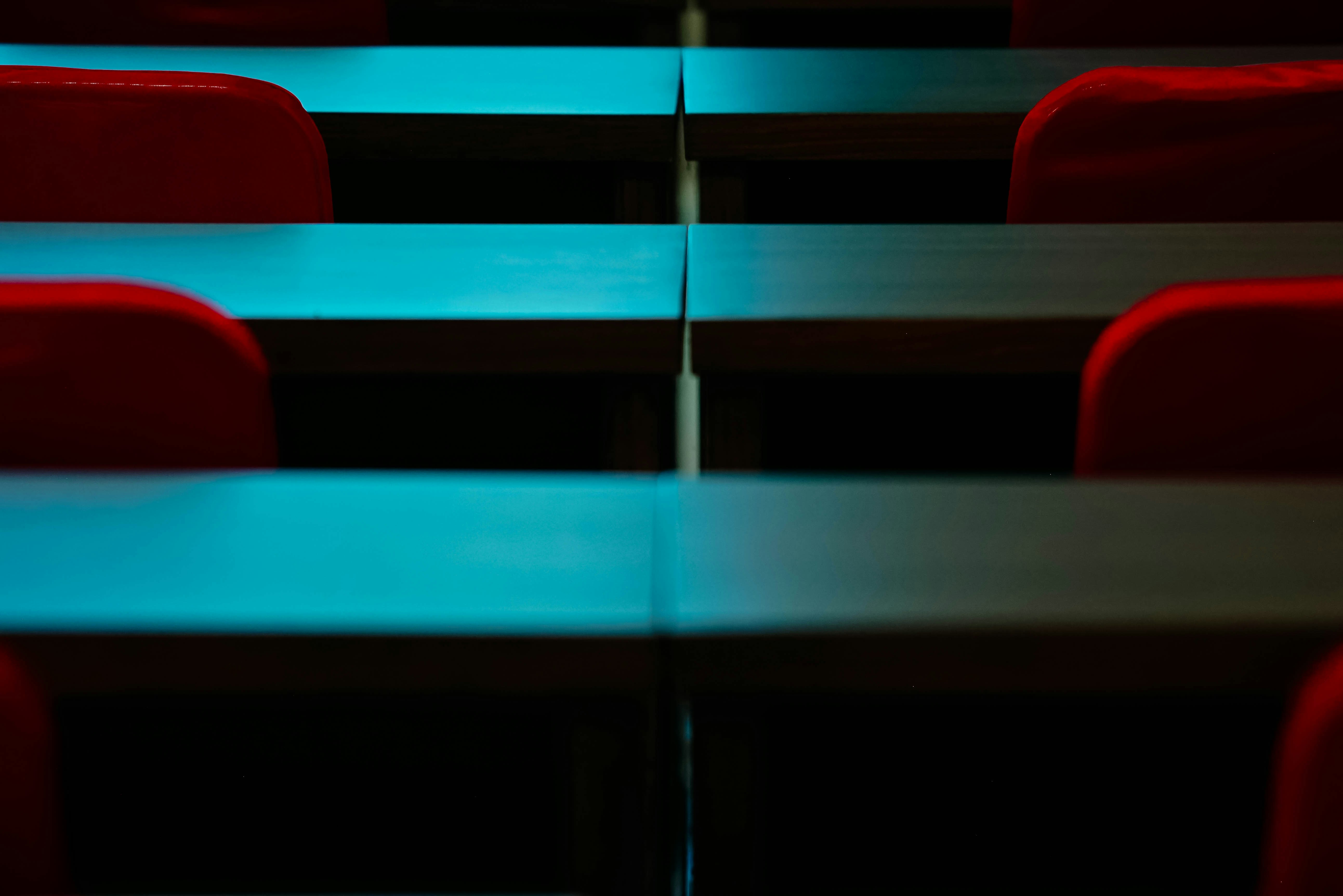a row of red chairs sitting next to each other
