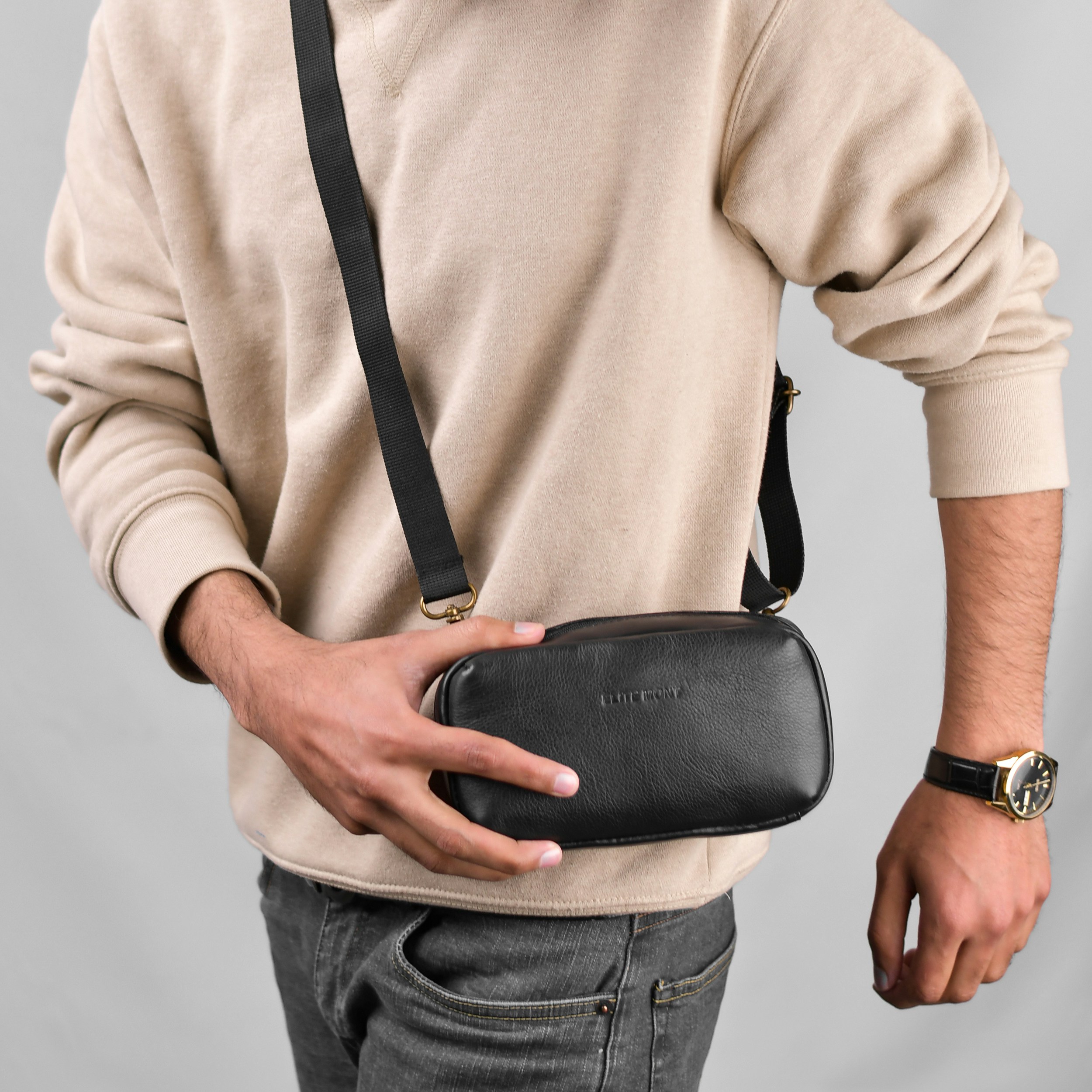 a man holding a black case in his left hand