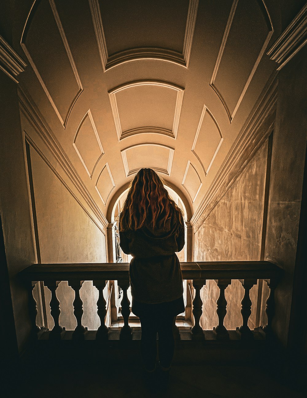 a woman standing on a staircase looking down