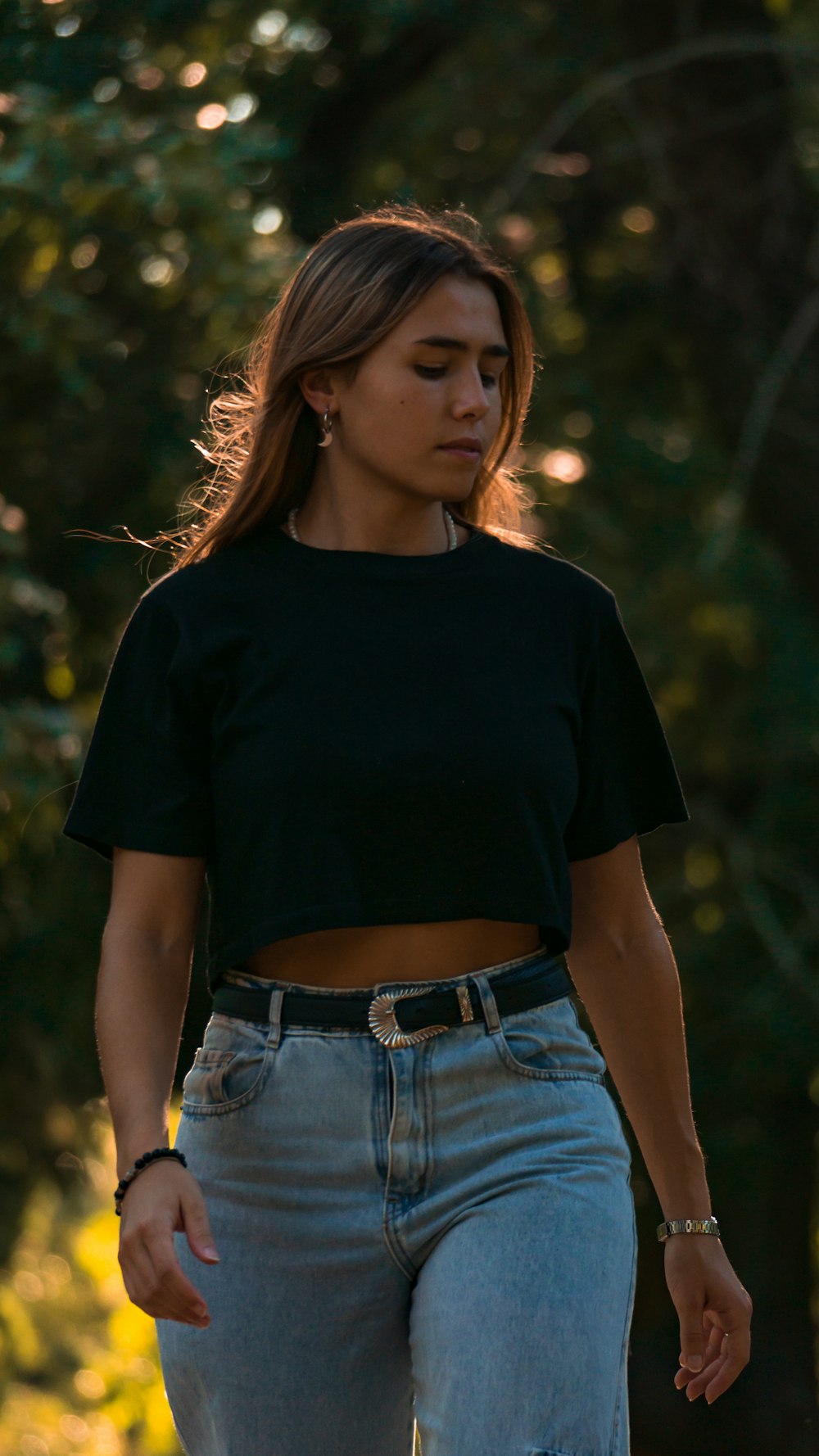 a woman in a black crop top and jeans