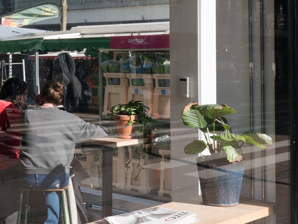 a woman standing in front of a store window