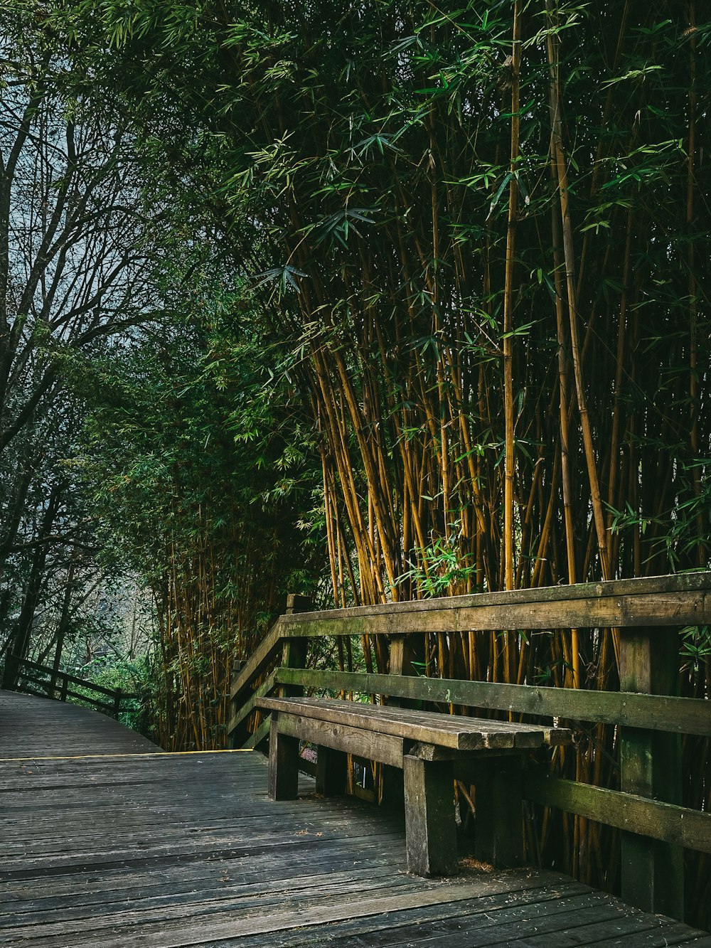 a wooden bench sitting on top of a wooden bridge