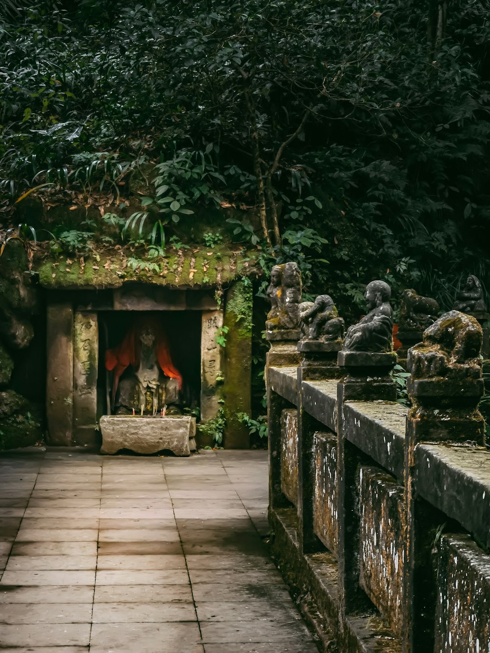 a stone walkway with a fire place in the middle of it
