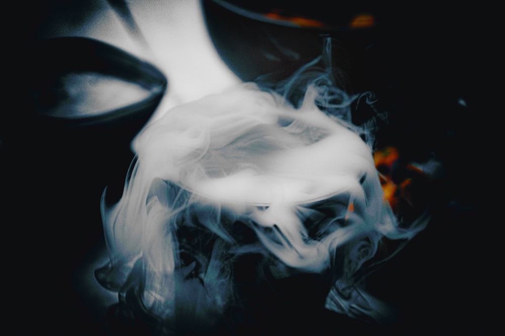 a black and white photo of smoke coming out of a pot