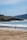 a person walking on a beach next to the ocean