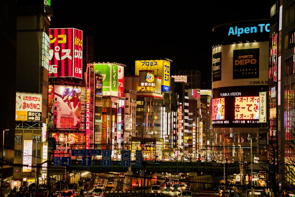 a city at night with lots of neon signs