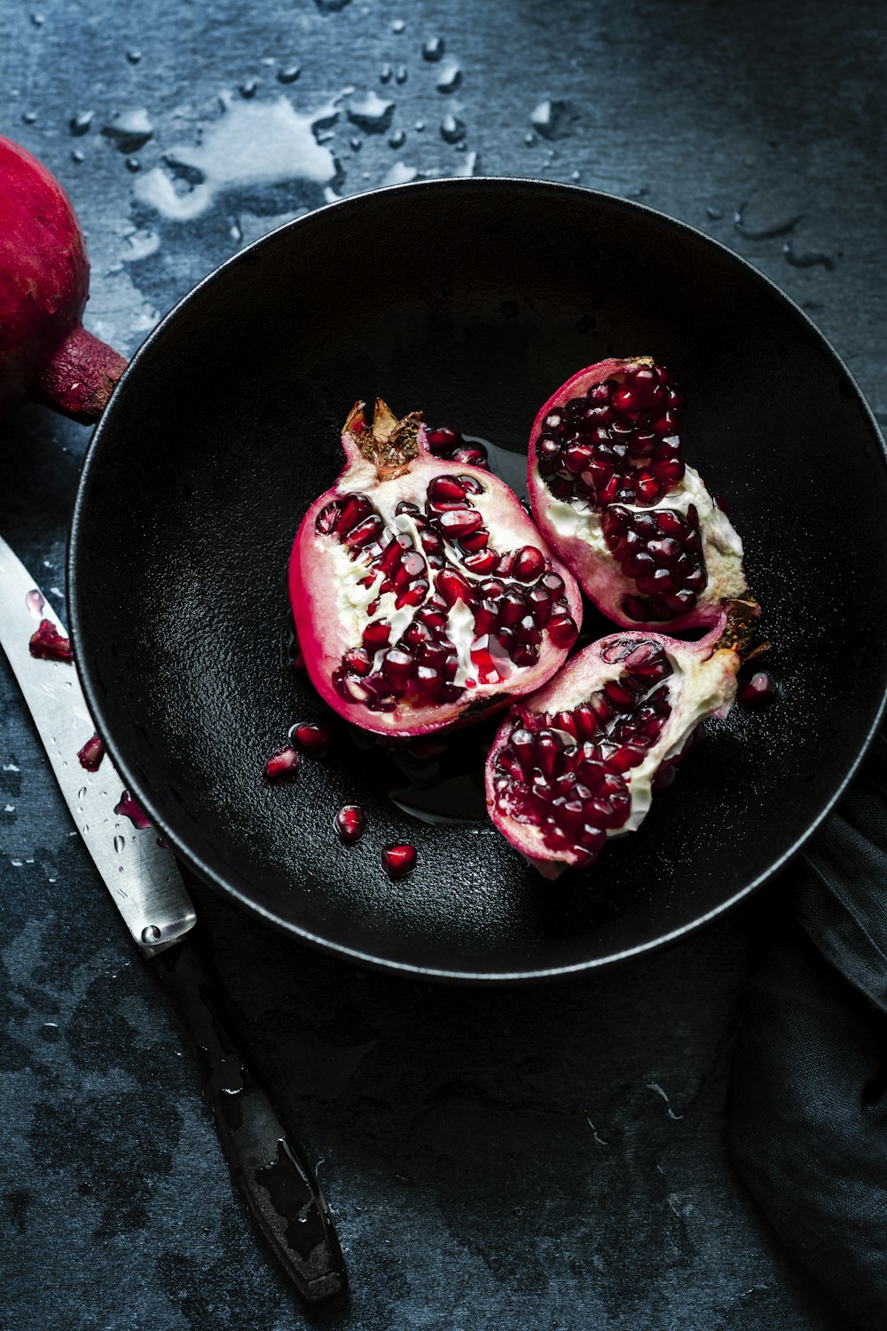 pomegranates in a frying pan on a table