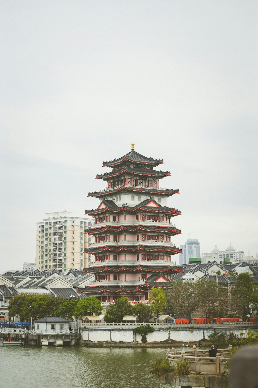 a tall building next to a body of water