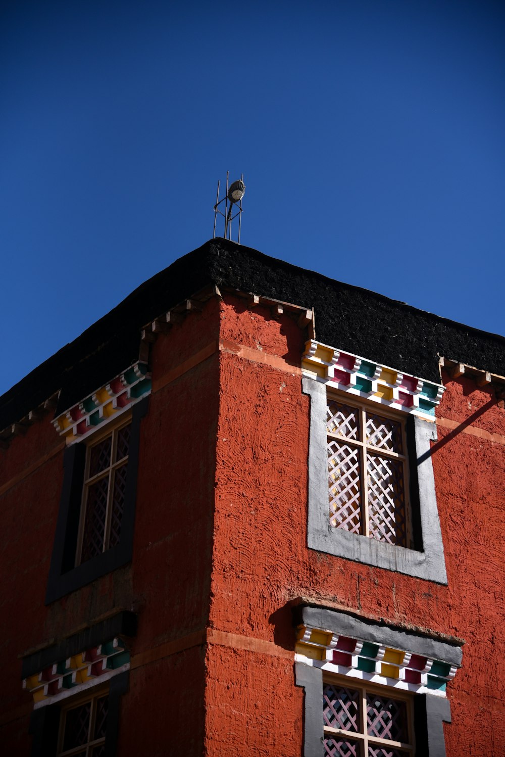 a red building with a bird on top of it