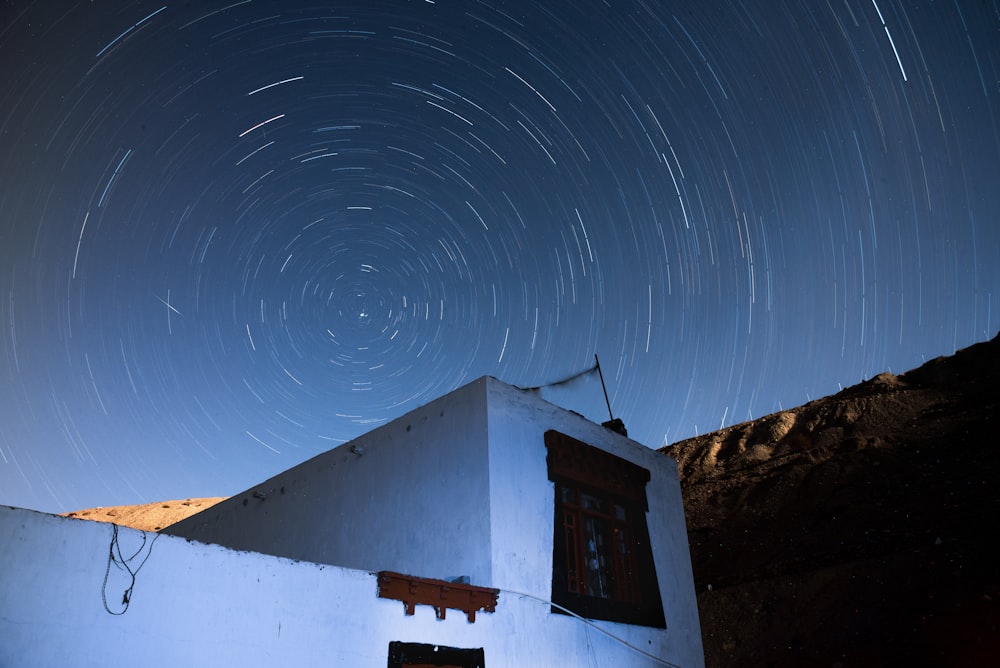 a house with a star trail in the sky