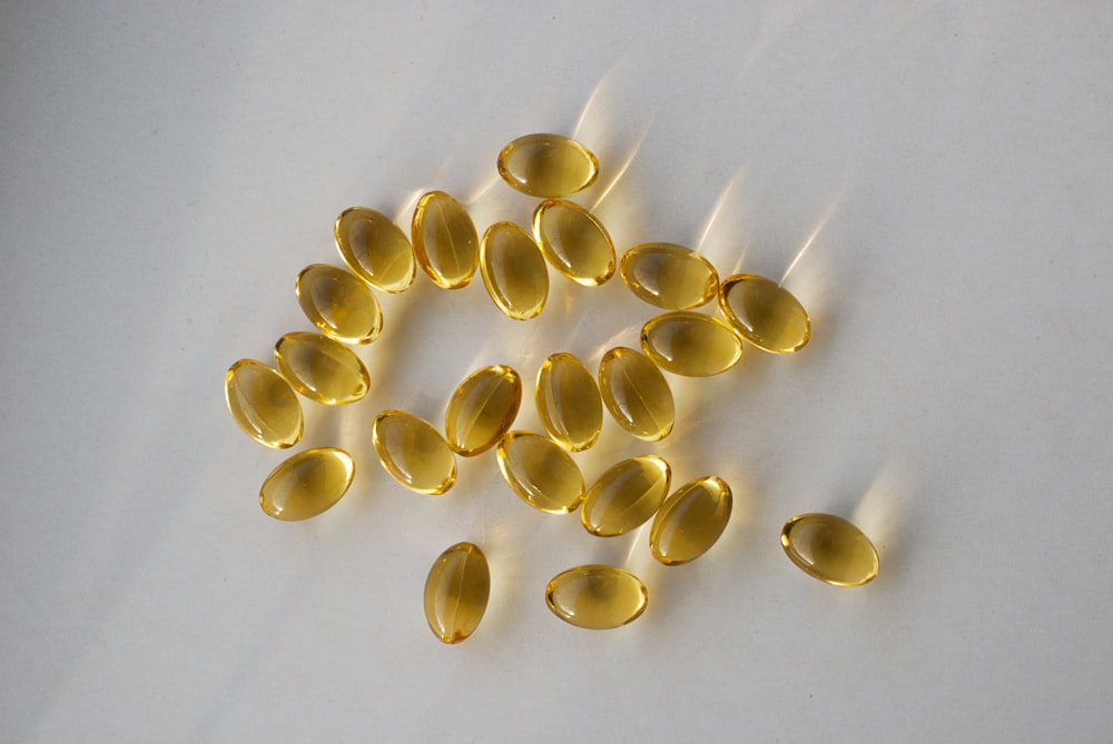 a pile of fish oil capsules sitting on top of a table